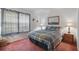 Comfortable bedroom featuring a plaid quilt, matching lamps, and natural light at 219 Tait Se Ter, Port Charlotte, FL 33952