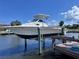 Sport craft boat sitting on a boat lift with a clear blue sky in the background at 219 Tait Se Ter, Port Charlotte, FL 33952