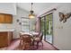 Cozy breakfast nook with a glass-top table, four chairs, and natural lighting from the window at 219 Tait Se Ter, Port Charlotte, FL 33952