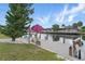 Waterfront dock featuring seating with an umbrella and access to the canal at 219 Tait Se Ter, Port Charlotte, FL 33952