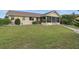 Charming home with a well-manicured lawn, screened patio and manicured landscaping at 219 Tait Se Ter, Port Charlotte, FL 33952