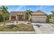 Beautiful single Gathering home with a well-maintained lawn and lush landscaping with a brick walkway at 219 Tait Se Ter, Port Charlotte, FL 33952