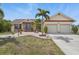 Inviting single Gathering home with a well-maintained lawn, mature landscaping, and a 2-car garage at 219 Tait Se Ter, Port Charlotte, FL 33952