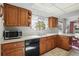 Functional kitchen featuring wooden cabinetry, modern appliances, and ample counter space at 219 Tait Se Ter, Port Charlotte, FL 33952