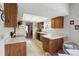 Bright kitchen with wooden cabinets, white countertops, and black appliances at 219 Tait Se Ter, Port Charlotte, FL 33952