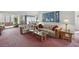 Cozy living room with a glass coffee table, plush seating, and bright natural light at 219 Tait Se Ter, Port Charlotte, FL 33952