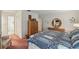 Spacious main bedroom with closet space, wooden dresser, and a floral accent chair at 219 Tait Se Ter, Port Charlotte, FL 33952