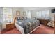 Bright and airy main bedroom with patterned quilt and matching side tables at 219 Tait Se Ter, Port Charlotte, FL 33952