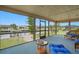 Relaxing screened-in patio with beautiful waterfront views and comfortable wicker furniture at 219 Tait Se Ter, Port Charlotte, FL 33952