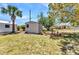 Backyard shed providing extra storage in the grass-filled yard at 22299 Laramore Ave, Port Charlotte, FL 33952