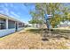 Expansive backyard with mature trees and a birdhouse at 22299 Laramore Ave, Port Charlotte, FL 33952