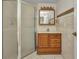 Traditional bathroom featuring a shower, wood vanity, medicine cabinet, and tiled walls at 22299 Laramore Ave, Port Charlotte, FL 33952