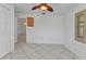 Bedroom featuring tile floors, shuttered window, and neutral paint at 22299 Laramore Ave, Port Charlotte, FL 33952