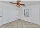 Bedroom with tile floors, shuttered window, and ceiling fan at 22299 Laramore Ave, Port Charlotte, FL 33952