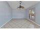 Bedroom featuring neutral paint, tile flooring, and a shuttered window at 22299 Laramore Ave, Port Charlotte, FL 33952