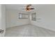 Bedroom showcasing tile floors, shuttered windows, and accessible grab bar at 22299 Laramore Ave, Port Charlotte, FL 33952