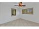 Bedroom featuring tile flooring, neutral paint, ceiling fan, and shuttered windows at 22299 Laramore Ave, Port Charlotte, FL 33952