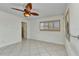 Bedroom featuring tile floors, neutral paint, ceiling fan, and shuttered windows at 22299 Laramore Ave, Port Charlotte, FL 33952