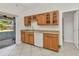 Functional kitchen featuring wooden cabinets, a dishwasher, and a view of the screened-in porch at 22299 Laramore Ave, Port Charlotte, FL 33952