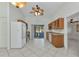 Spacious kitchen with white appliances, wooden cabinets, and access to an outdoor patio at 22299 Laramore Ave, Port Charlotte, FL 33952