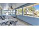 Enclosed lanai featuring two ceiling fans, outdoor seating, and a view of the backyard at 22299 Laramore Ave, Port Charlotte, FL 33952