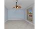 Bright living room featuring tile flooring, a ceiling fan, and a window with wood-look shutters at 22299 Laramore Ave, Port Charlotte, FL 33952