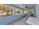 Covered porch featuring ceiling fans and views of the spacious backyard at 22299 Laramore Ave, Port Charlotte, FL 33952