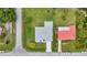 A high-angle view of a single-story home showcasing its roof, driveway, and the surrounding landscaped yard at 229 Waterside St, Port Charlotte, FL 33954