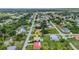 Aerial view showcasing the property's location within a neighborhood, featuring a mix of homes and landscaping at 229 Waterside St, Port Charlotte, FL 33954