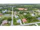 Community aerial view showing houses in a neighborhood with mature trees and well-manicured lawns at 229 Waterside St, Port Charlotte, FL 33954