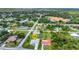 Aerial view of a neighborhood, highlighting the property's location in a residential area surrounded by lush greenery at 229 Waterside St, Port Charlotte, FL 33954