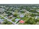 An elevated view of a residential neighborhood featuring well-maintained homes, mature trees, and green lawns at 229 Waterside St, Port Charlotte, FL 33954