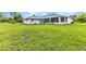 Spacious green backyard featuring a well-maintained lawn surrounding the house at 229 Waterside St, Port Charlotte, FL 33954