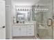 Modern bathroom boasts a sleek vanity with ample storage, a frameless glass shower, and stylish fixtures at 229 Waterside St, Port Charlotte, FL 33954