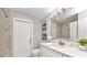 Bright bathroom features a shower with marble tile, a white vanity, and modern fixtures at 229 Waterside St, Port Charlotte, FL 33954