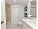 Bright bathroom features a shower with tile, a white vanity, and modern fixtures at 229 Waterside St, Port Charlotte, FL 33954