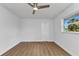 Spacious bedroom with wood-look flooring, a ceiling fan, and bright window at 229 Waterside St, Port Charlotte, FL 33954