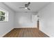 Empty bedroom with wood-look flooring, a ceiling fan, and a bright window at 229 Waterside St, Port Charlotte, FL 33954