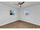 Bright bedroom features two windows, neutral walls, and modern flooring for a cozy retreat at 229 Waterside St, Port Charlotte, FL 33954