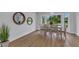 The dining area features gorgeous wood floors, neutral walls, natural light and decorative mirrors at 229 Waterside St, Port Charlotte, FL 33954