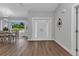 The entryway features beautiful wood floors, a modern light fixture and a view into the dining area at 229 Waterside St, Port Charlotte, FL 33954