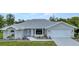 Charming single Gathering home boasting a beautifully landscaped front yard and a pristine white exterior at 229 Waterside St, Port Charlotte, FL 33954