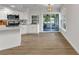 Bright kitchen features white cabinetry, stainless steel appliances, and seamless access to an inviting screened-in porch at 229 Waterside St, Port Charlotte, FL 33954