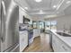 This renovated kitchen boasts stainless steel appliances, white cabinets, and an adjacent screened-in porch at 229 Waterside St, Port Charlotte, FL 33954
