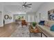 Bright living room with dining area, wood floors, and a comfortable seating arrangement at 229 Waterside St, Port Charlotte, FL 33954