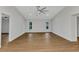 Large living room with wood-look floors, white walls, and two bright windows at 229 Waterside St, Port Charlotte, FL 33954