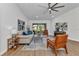Cozy living room with wood floors, modern ceiling fan, and a view of the backyard at 229 Waterside St, Port Charlotte, FL 33954