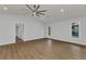 Spacious living room with wood-look floors, white walls, and two bright windows at 229 Waterside St, Port Charlotte, FL 33954