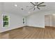 Bright living room with wood-look floors, white walls, and two bright windows at 229 Waterside St, Port Charlotte, FL 33954