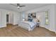 Relaxing main bedroom with wood floors, large windows, and calming color palette at 229 Waterside St, Port Charlotte, FL 33954